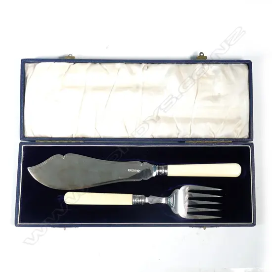 A pair of silver fish servers with ivory handles