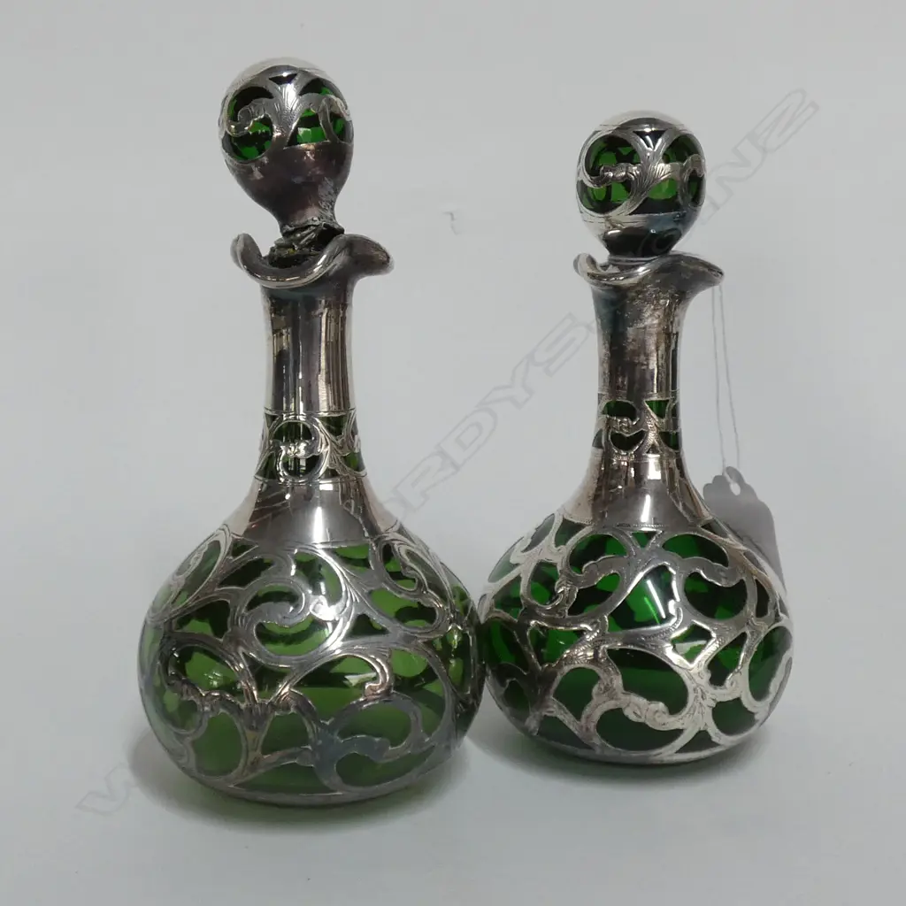 A pair of late Victorian silver over green glass scent bottles Image 1++