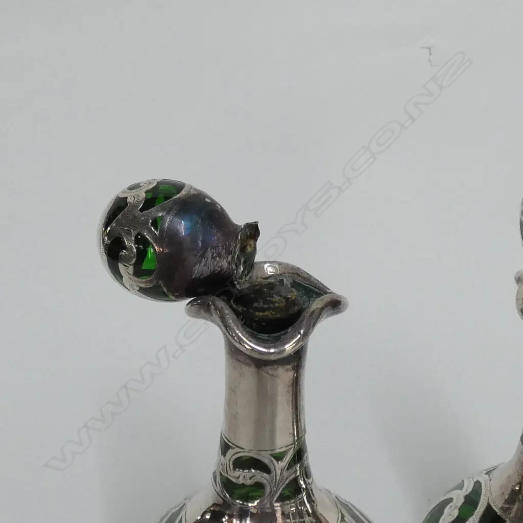 A pair of late Victorian silver over green glass scent bottles Image 1++