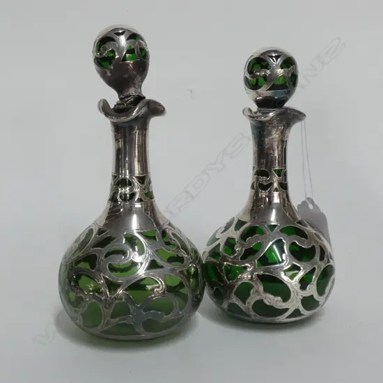 A pair of late Victorian silver over green glass scent bottles