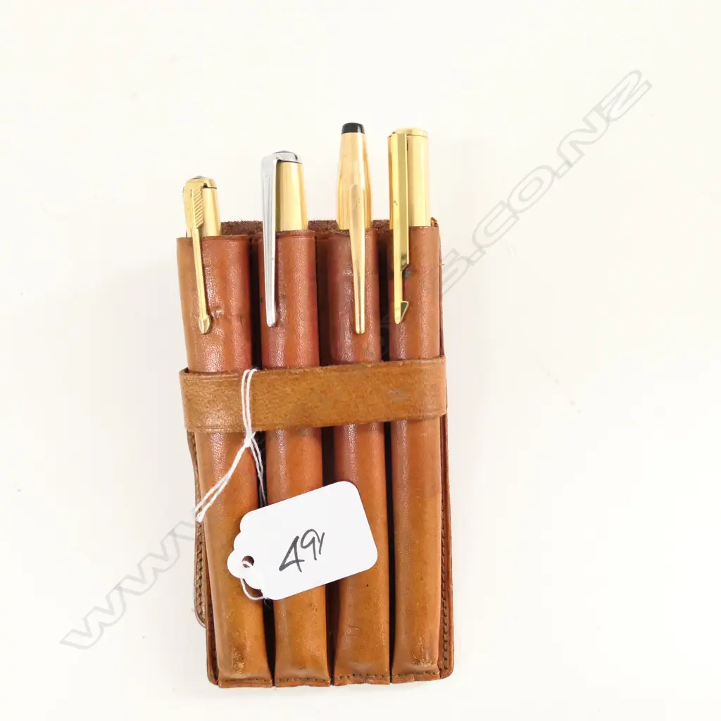FOUR GOLD PLATED PENS IN LEATHER HOLDER Image 1++