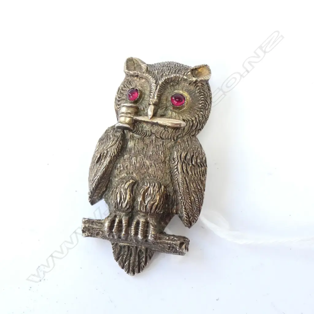 '1897 OWL CLUB' PRESENTATION S/PLATE OWL BUTTON HOLE BADGE. Slid cast and of good size fine detail red stone eyes. The owl with gavel to its mouth. The back engraved 'PRESENTED TO THE OWL CLUB BY J.A.BIRTS 1897'. With button hole fitting. H.52mm. Note: The Owl Club was founded in 1896 by Reginald Mansfield Johnson Image 1++