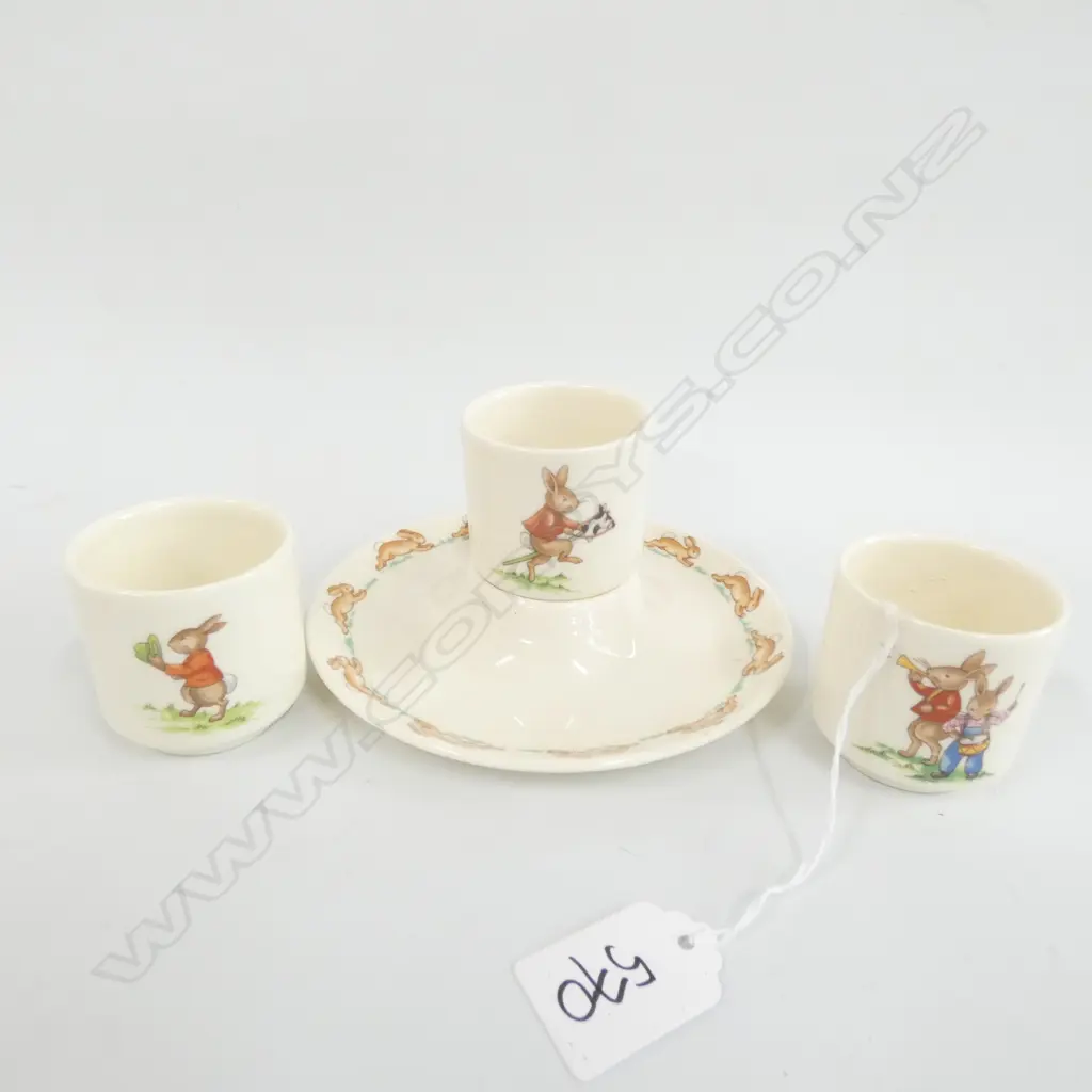 FOUR ROYAL DOULTON BUNNYKINS EGG CUPS, ONE WITH PLATE SURROUND Image 1++
