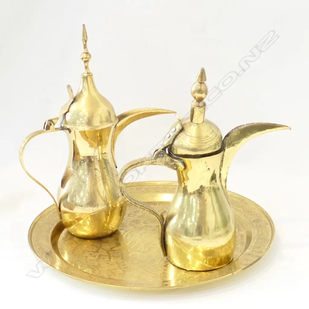 TWO ARAB BRASS TEAPOTS, TEASPOON AND TRAY 380MM DIA Image 1++