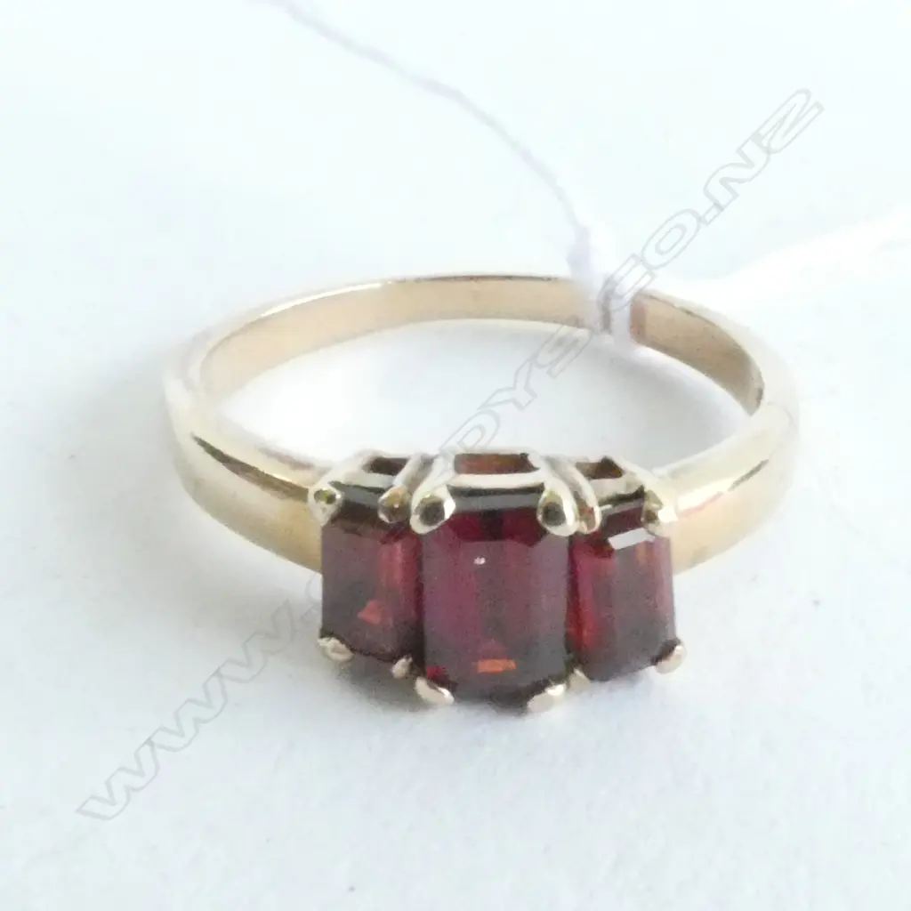 9CT RING SET WITH A BRIDGE OF 3 GARNETS Image 1++