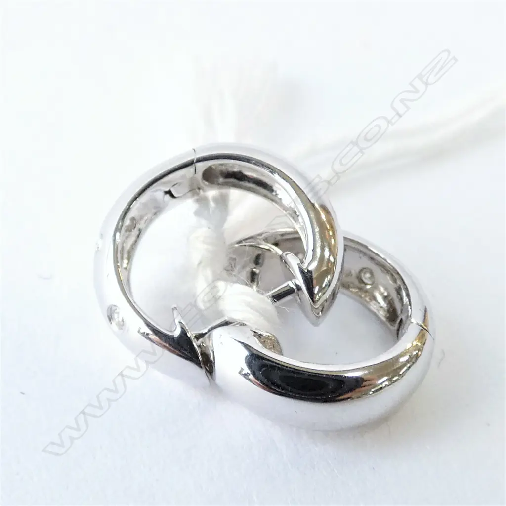 A pair of 9ct white gold and diamond earrings Image 1++