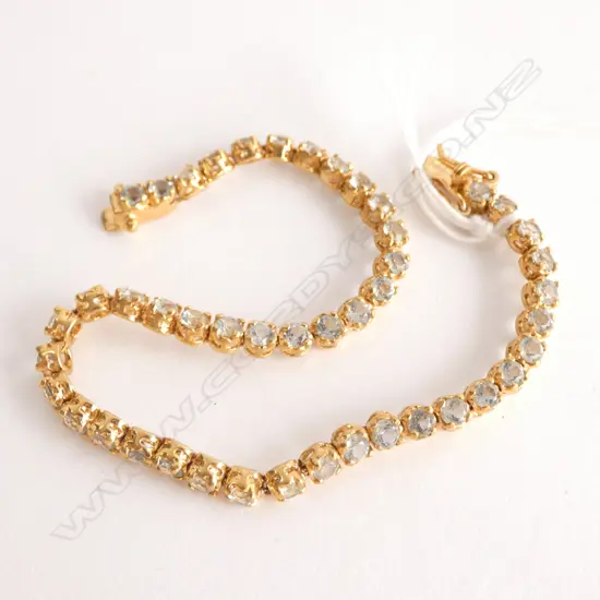 18CT GOLD PLATED AND AQUAMARINE TENNIS BRACELET (LOW GRADE AQUAMARINES)