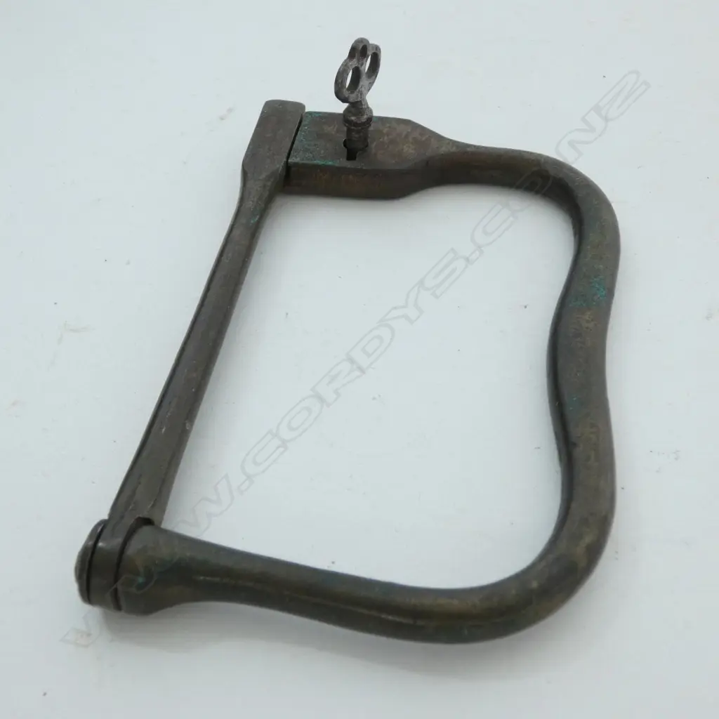 A brass Kit Bag Lock with an internal lock. Kit Bag locks were useful pieces of equipment to the traveler or soldier. They could be used to secure your luggage to railings at a station or on a train Image 1++