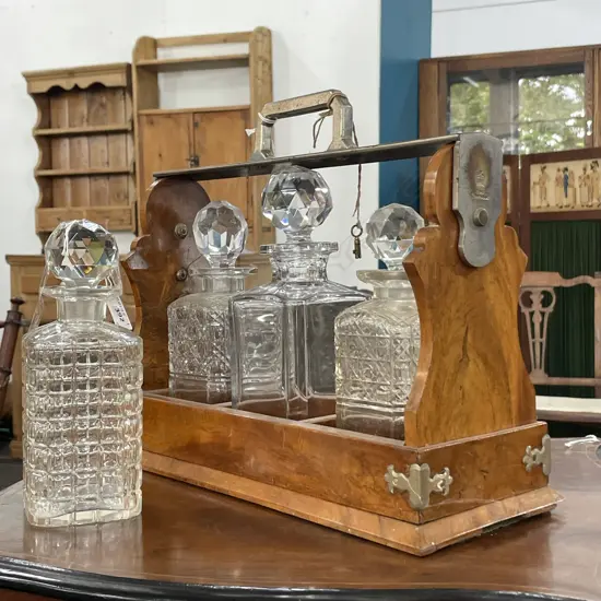ANTIQUE TANTALUS WITH FIVE VARIOUS DECANTERS.  MAKER G BETJEMANN & SONS LONDON 
