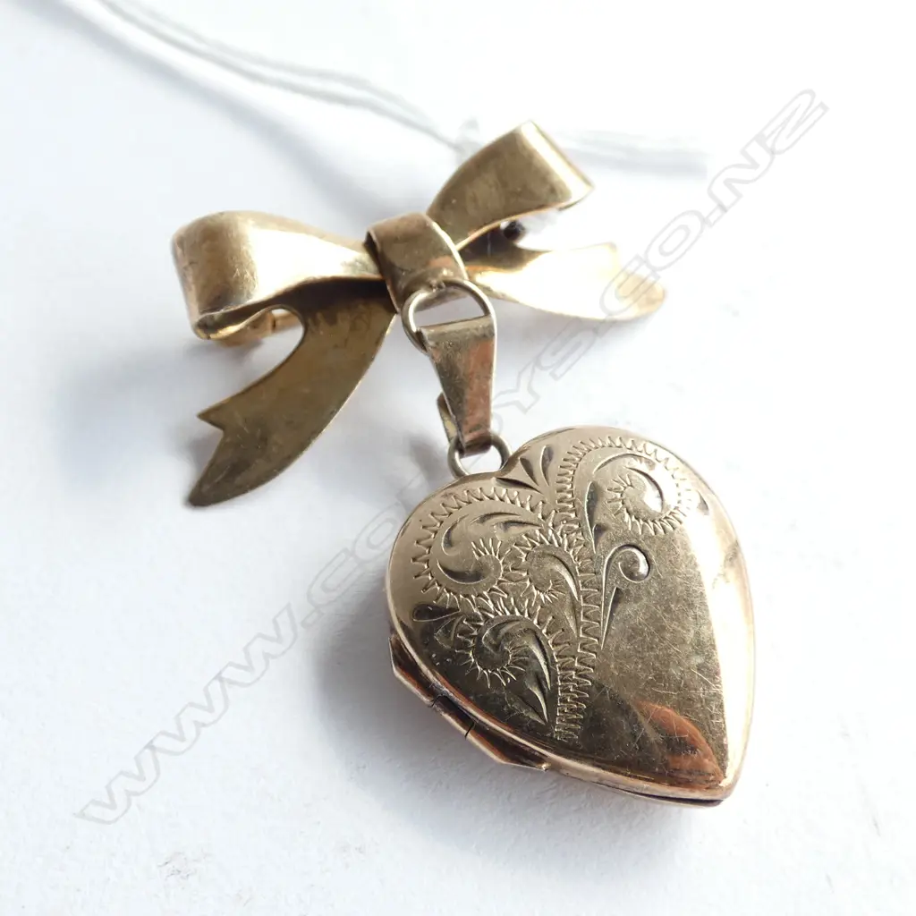 (002) 9ct on STERLING HEART LOCKET ON BOW BROOCH Image 1++