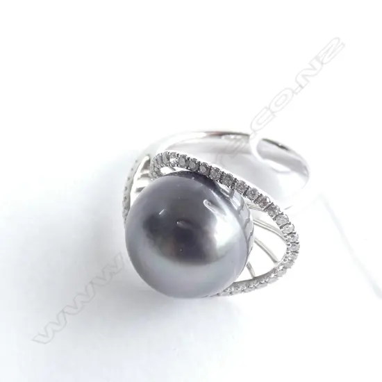 An 18ct white gold black pearl and diamond dress ring,