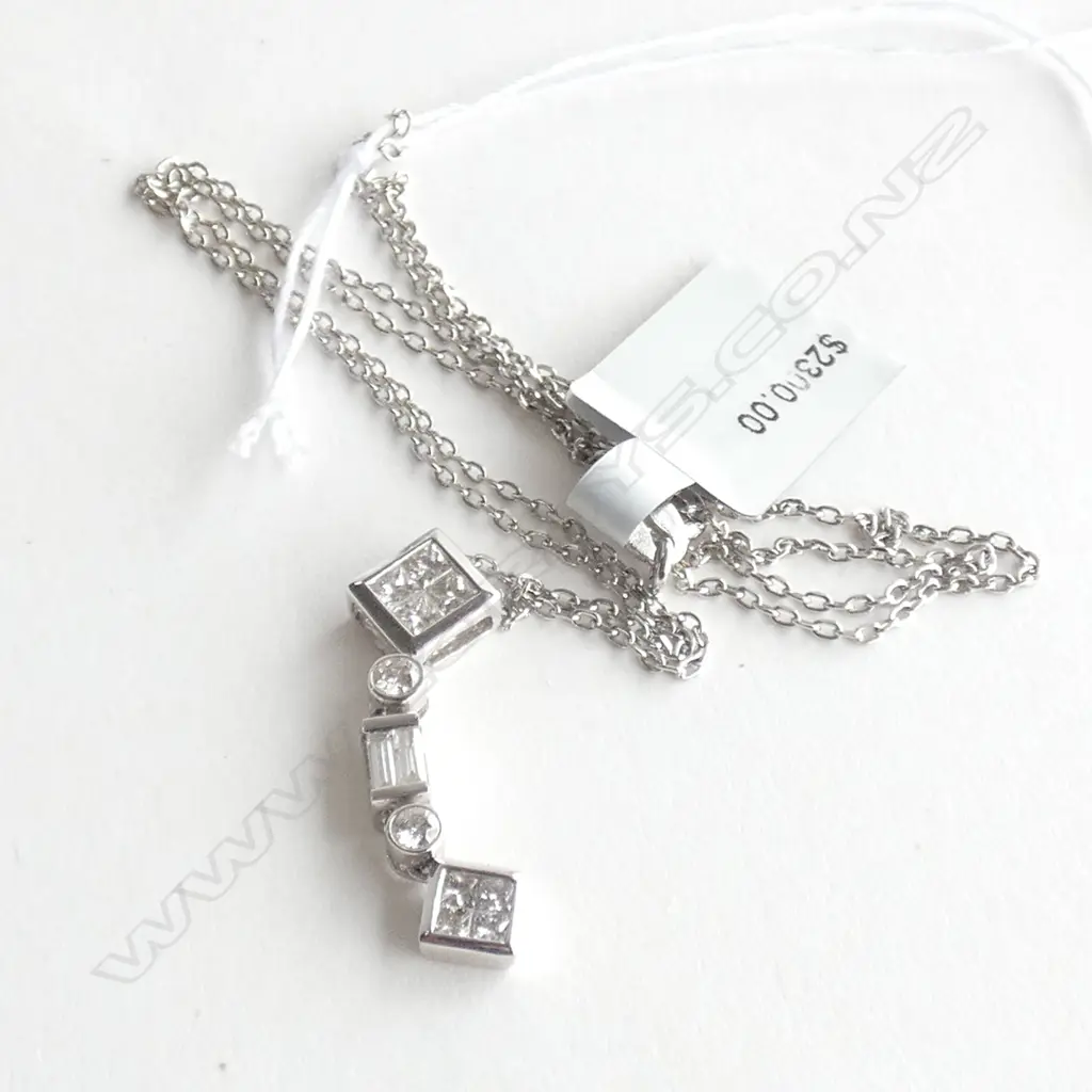 An 18ct white gold and diamond pendant, Image 1++