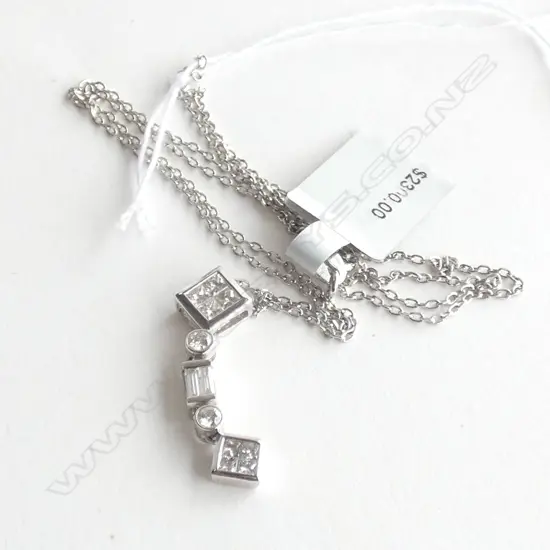 An 18ct white gold and diamond pendant,