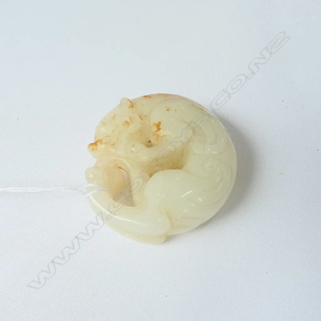 CHINESE WHITE JADE CIRCULAR HANDLING PIECE WITH RUSSET SURFACE INCLUSIONS OF A MYTHICAL ANIMAL . DIA.52mm Image 1++