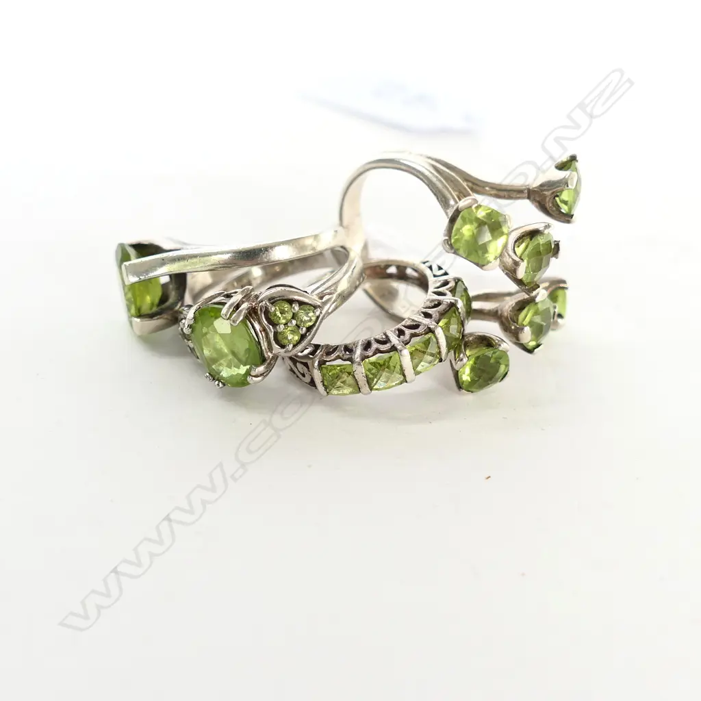 FOUR SILVER AND PERIDOT RINGS Image 1++