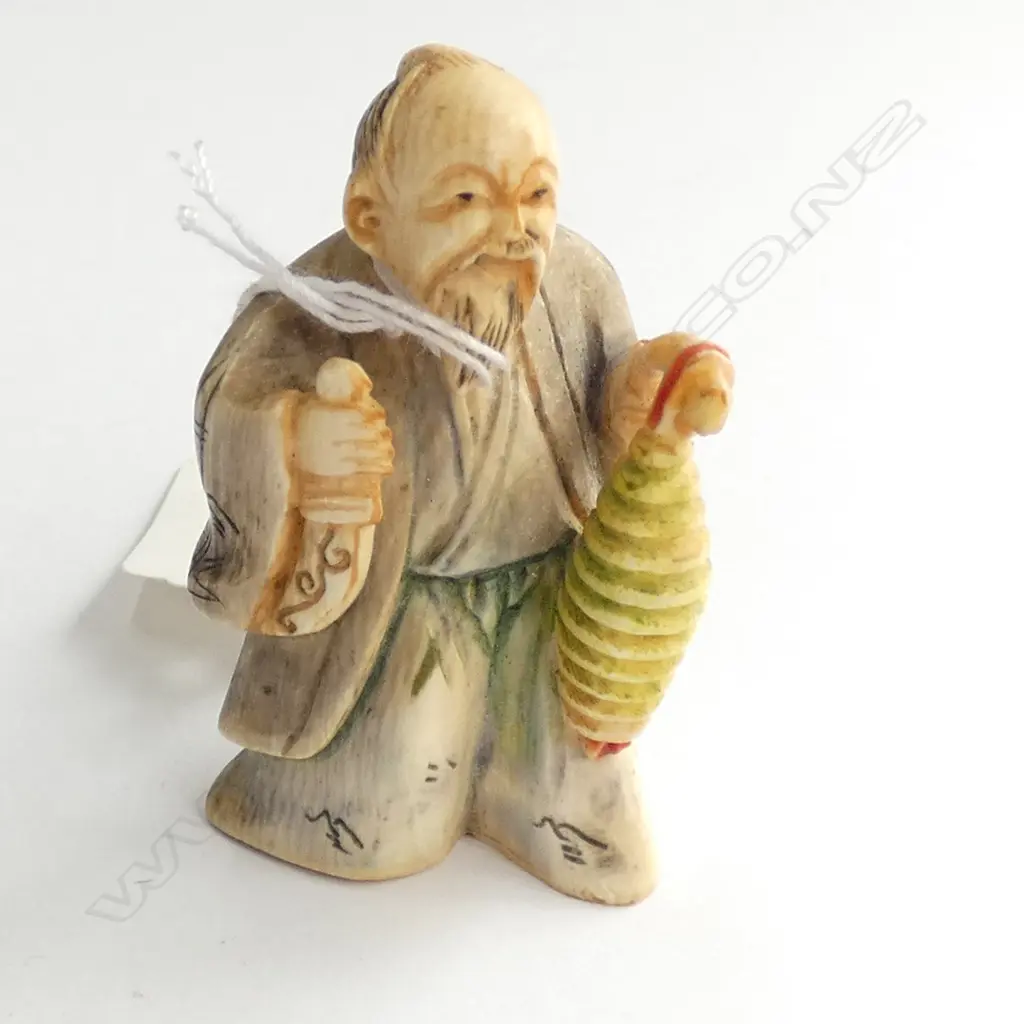 JAPANESE CARVED IVORY NETSUKE MAN WITH.... Image 1++