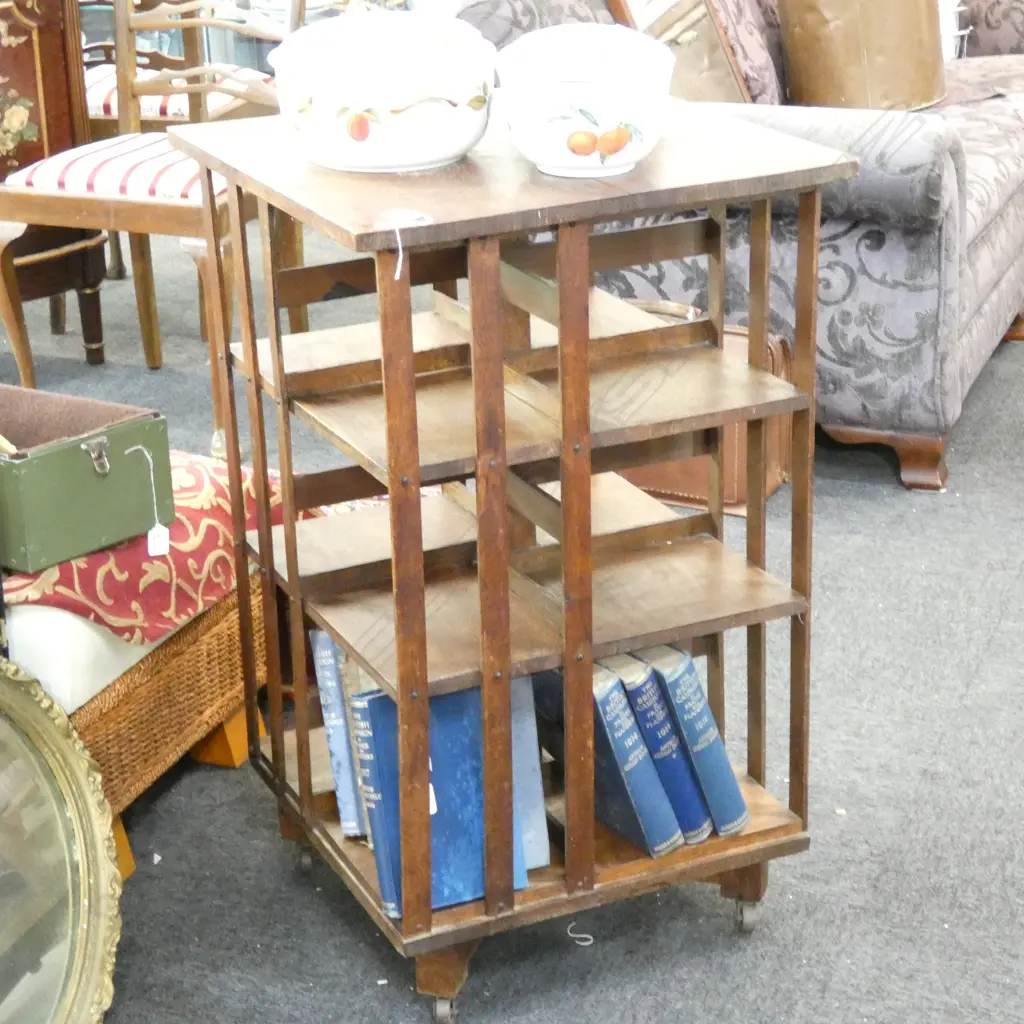 A REVOLVING OAK BOOKSHELF ON CASTERS Image 1++