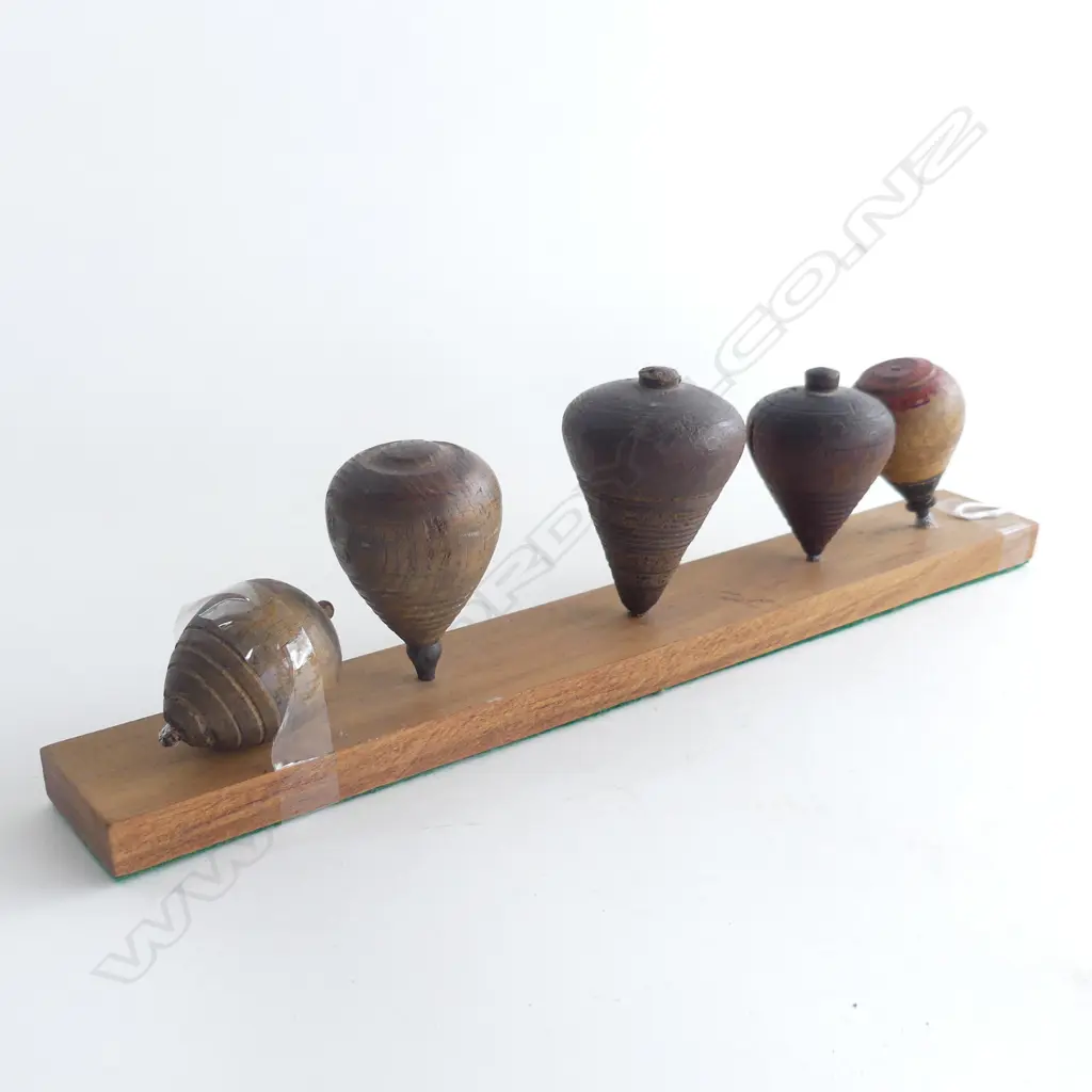 (90) A SET OF 5 SPINNING TOPS ON PURPOSE MADE BOARD 320MM LONG Image 1++