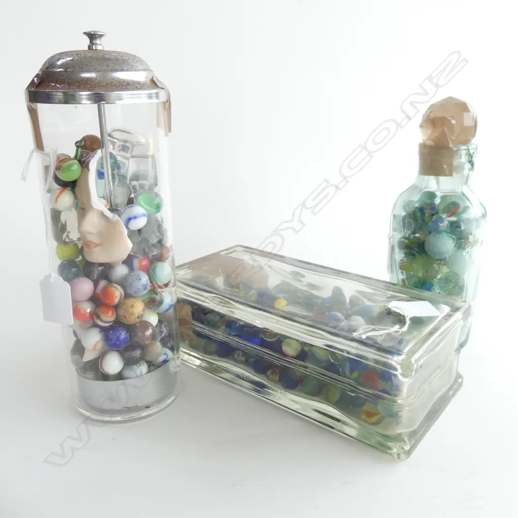 (81)  3 GLASS CONTAINERS CONTAINING MARBLES,OBLONG,CIRCULAR & AN OLD BOTTLE, STOPPERS DOLLFACE IN CIRCULAR ONE , H.270mm Image 1++