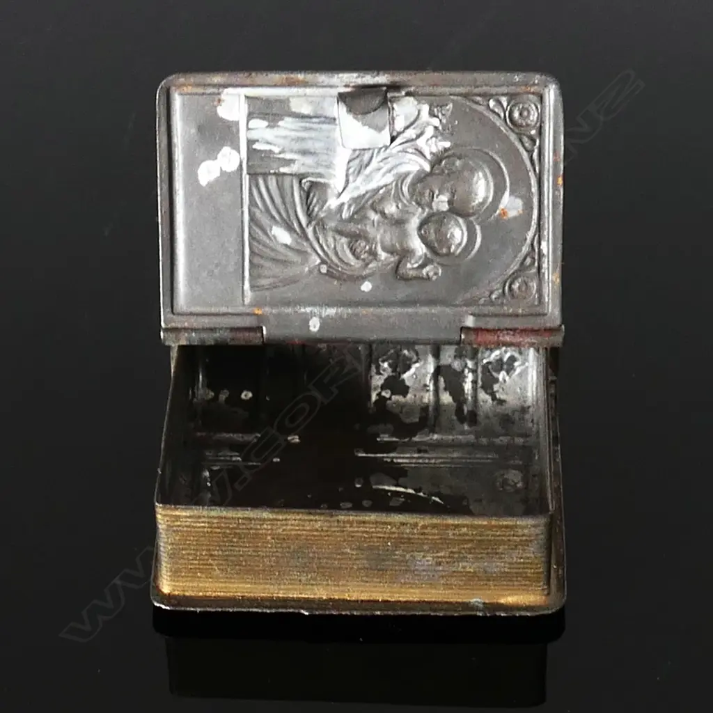 Small Metal Box in the shape of a book, hinged front cover embossed with image of an icon of St Joseph holding the child Jesus Image 1++
