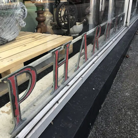 'PHARMACY' SHOP SIGN, PAINTED BRONZE INDIVIDUAL LETTERS ON ALUMINIUM RAIL MOUNTS. 2400 x 240mm APPROX