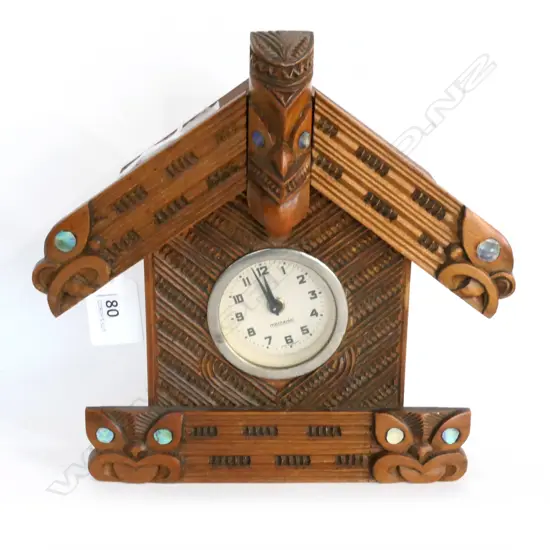 MAORI ART CLOCK, MODELLED AS A WHARE WHAKIRO, MERCEDES MOVEMENT. H.210mm