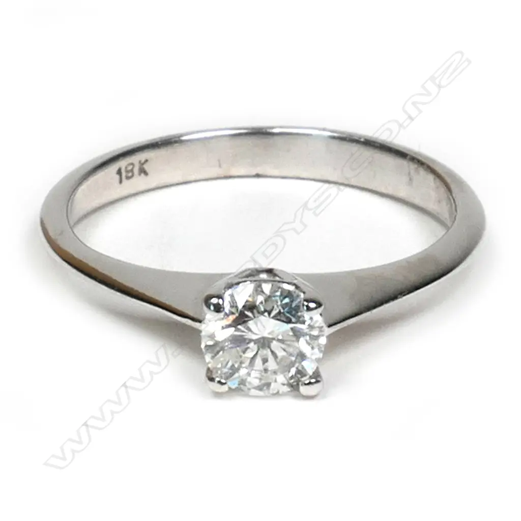 An 18ct white gold and diamond solitaire ring  0.35ct modern round brilliant cut diamond (Colour H, Clarity I1) claw set in a plain tapering shank, upswept shoulders. Valuation available. Image 1++