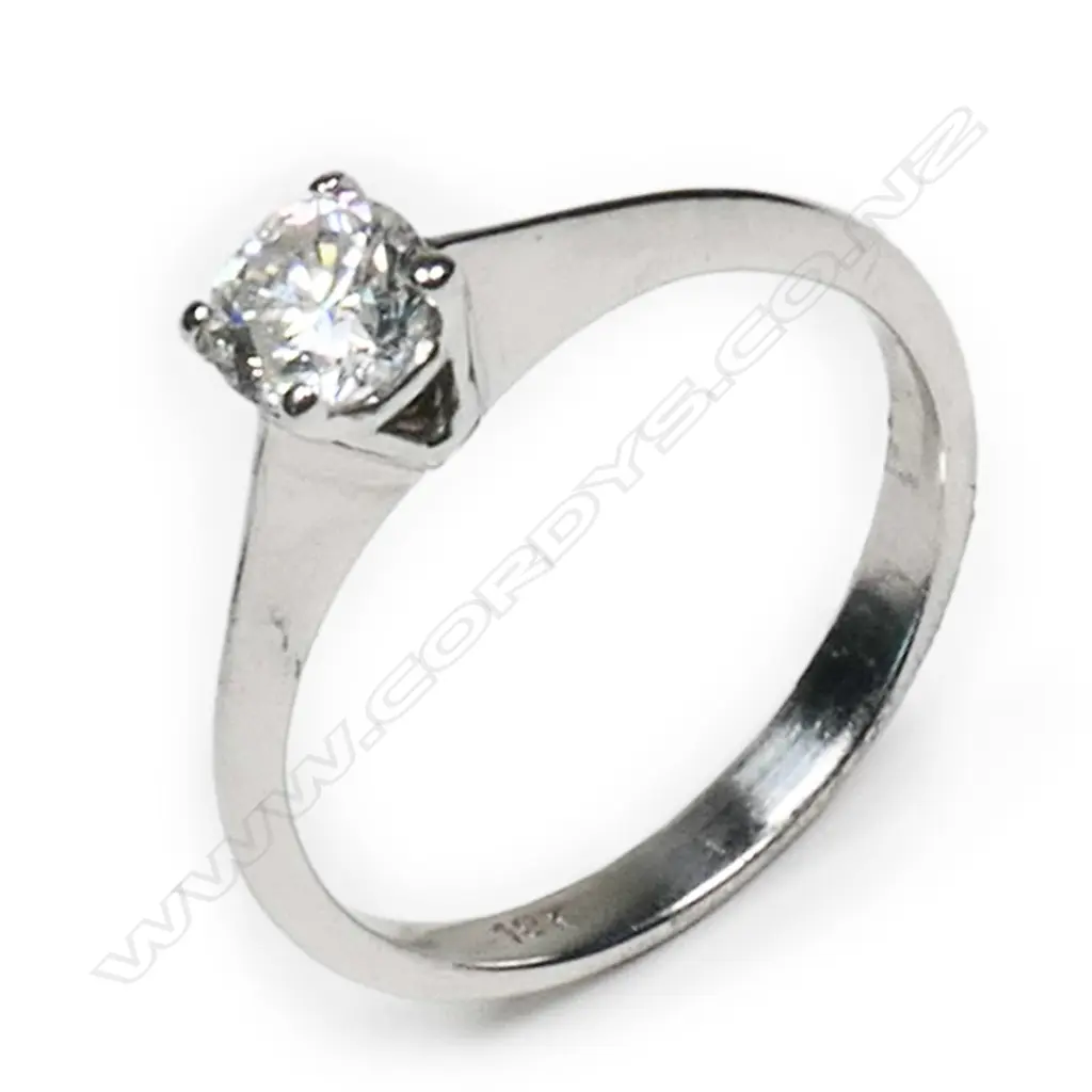 An 18ct white gold and diamond solitaire ring  0.35ct modern round brilliant cut diamond (Colour H, Clarity I1) claw set in a plain tapering shank, upswept shoulders. Valuation available. Image 1++