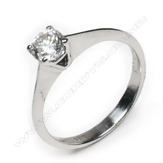 An 18ct white gold and diamond solitaire ring  0.35ct modern round brilliant cut diamond (Colour H, Clarity I1) claw set in a plain tapering shank, upswept shoulders. Valuation available.