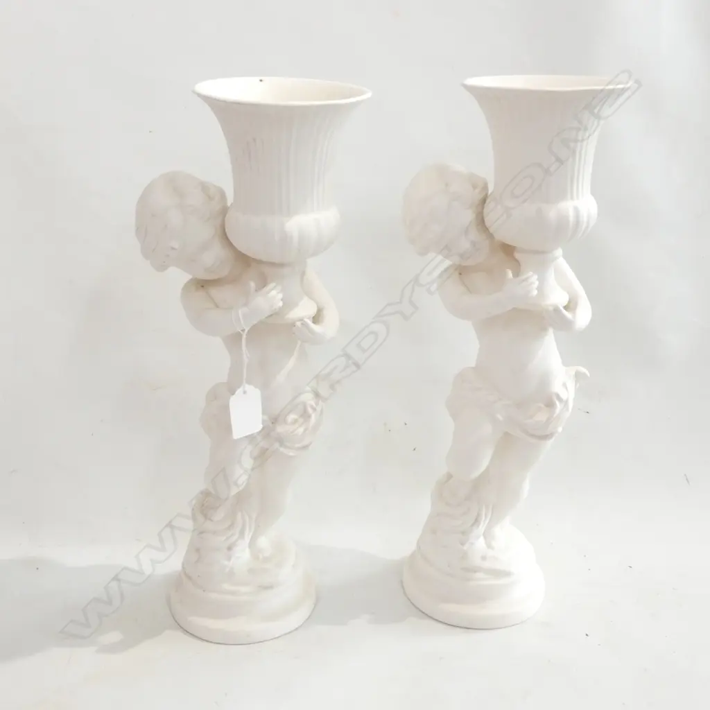 PR WHITE CERAMIC VASES; CHERUBS HOLDING URNS H.400mm Image 1++
