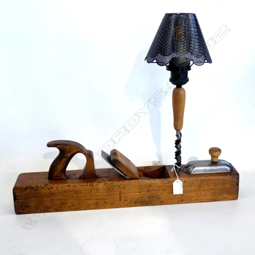 Old wooden plane 550mm long industrial shade and a rustic drill bit repurposed into an artisan lamp. Switch hidden under a breast drill cover and handle to form a weird and robust switch. Fitted with 12V 6W energy saving filament LED bulb with more than 25 Image 1++