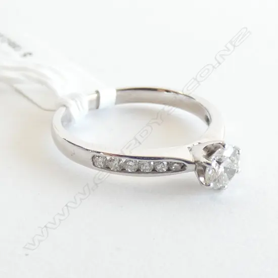  18CT WG SOLITAIRE RING 1 X 46PT DIAM, 12 X 1.5PT DIAM, 3.44G