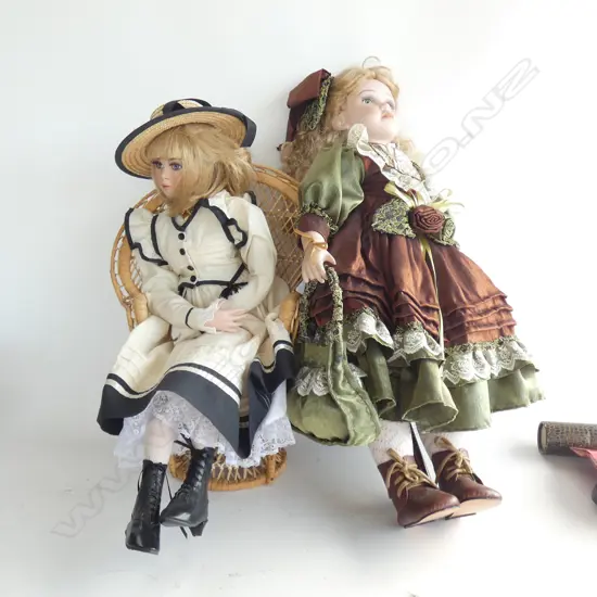 TWO PORCELAIN DOLLS 1 W STAND H.670MM & 1 SITTING CANE CHAIR (LEG BROKEN) H.485MM