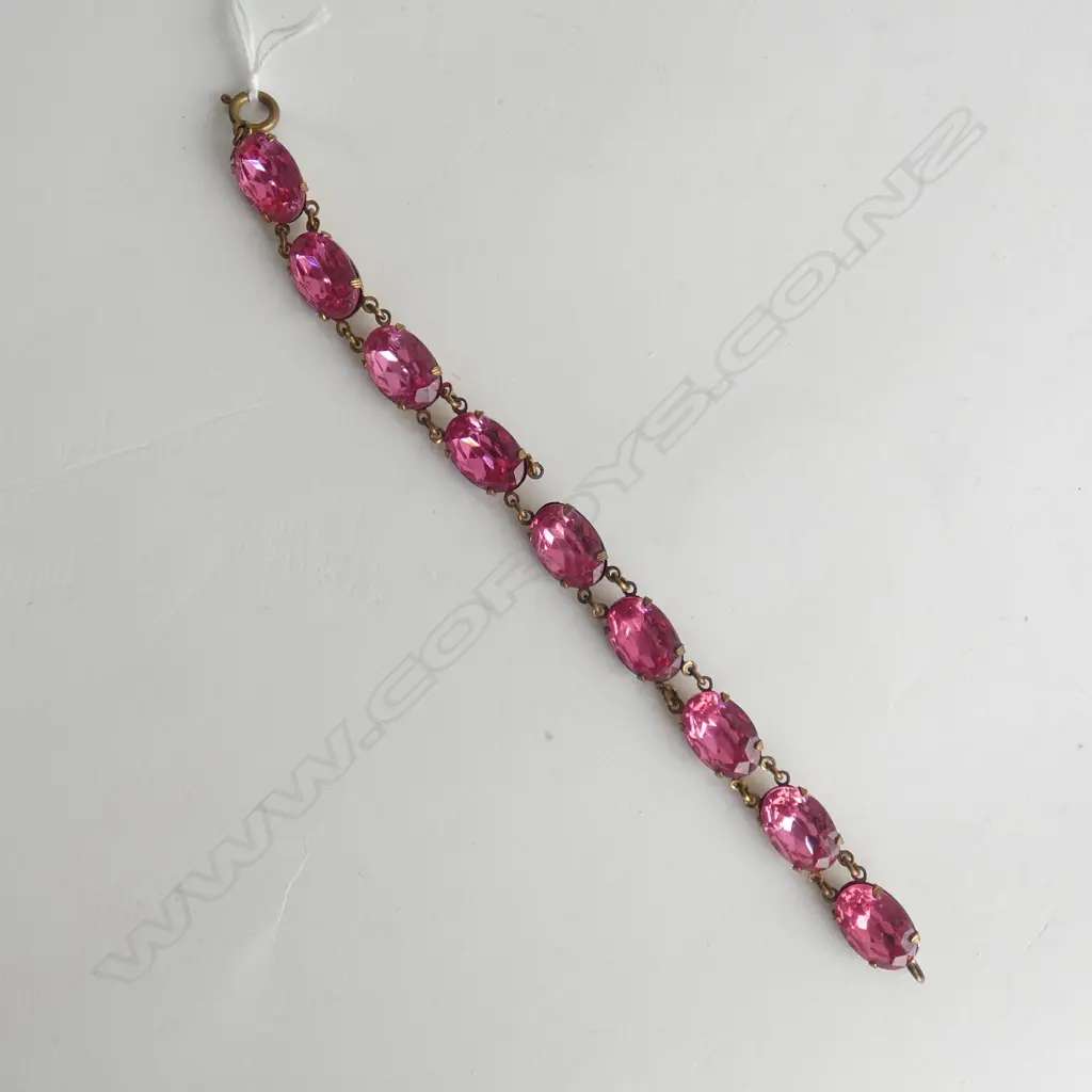 GOLD TONE BRACELET WITH PINK COLORED STONES, AF LINK BROKEN 200MM L. Image 1++