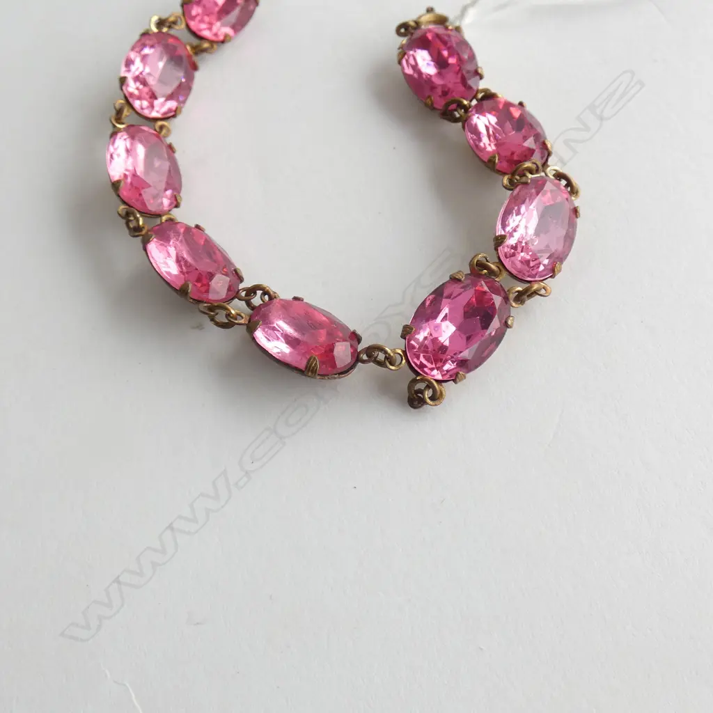 GOLD TONE BRACELET WITH PINK COLORED STONES, AF LINK BROKEN 200MM L. Image 1++