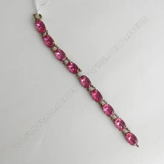 GOLD TONE BRACELET WITH PINK COLORED STONES, AF LINK BROKEN 200MM L.