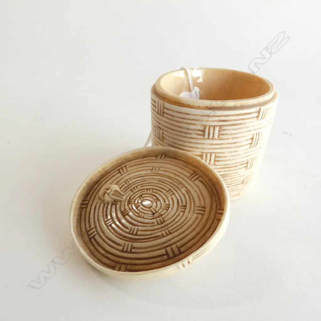 JAPANESE IVORY OKIMONO OF A MAN PEERING THROUGH THE LID OF A WOVEN BASKET Image 1++