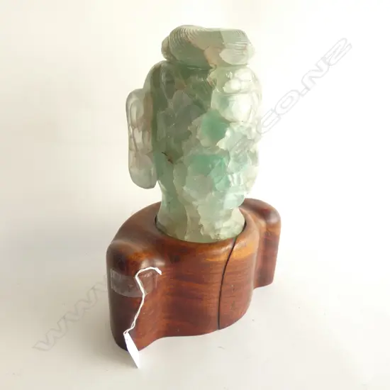 JADE-GREEN GLASS BUDDHA HEAD ON WOODEN STAND H.330mm