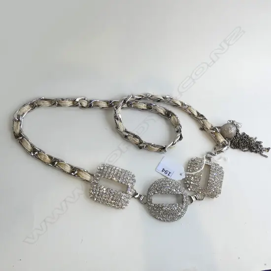 GLITZY CHAIN BELT WITH DIAMANTE STUDDED DECORATIVE BUCKLES + TASSLE DETAIL