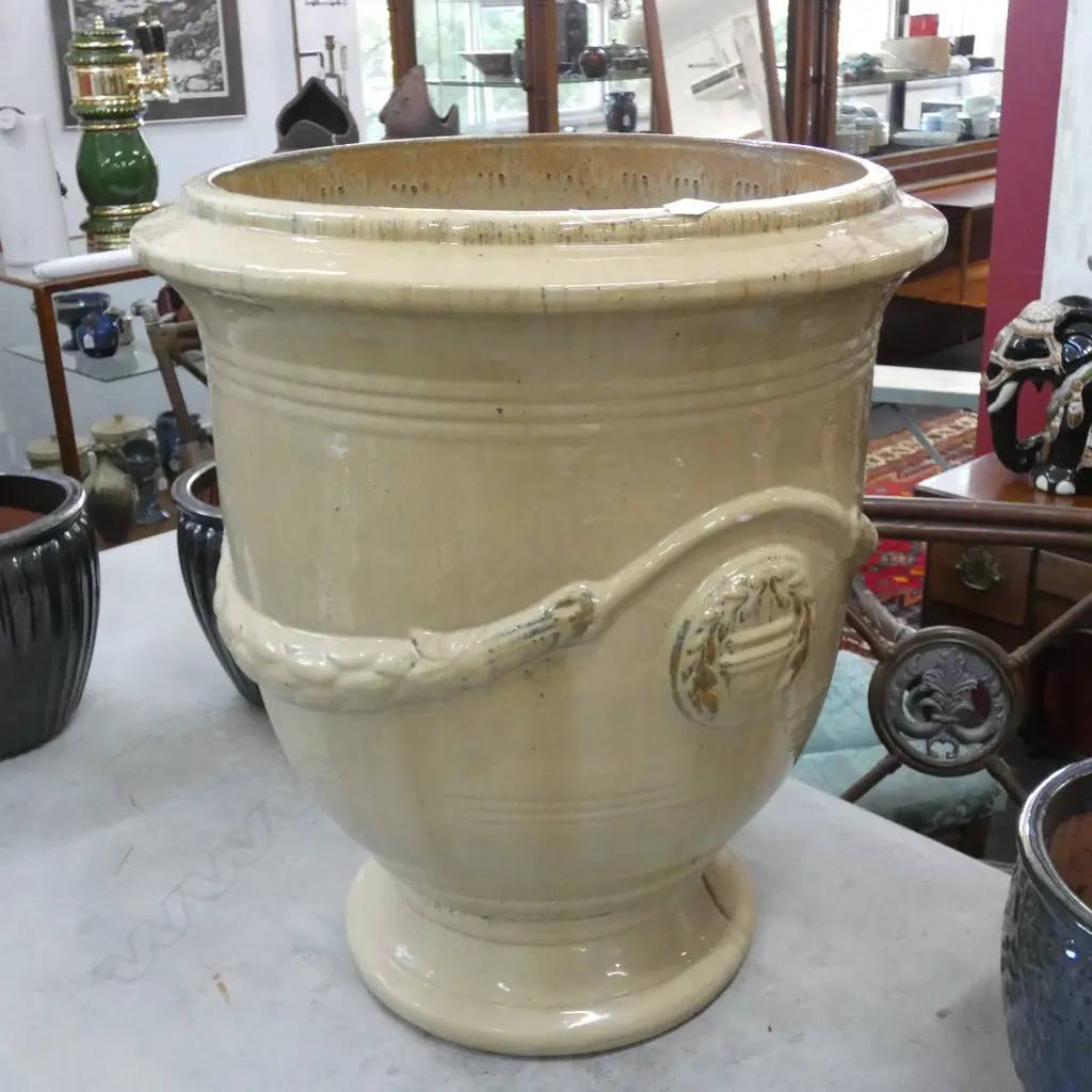 A LARGE TERRACOTTA GLAZED GARDEN URN WITH FRENCH STYLE SWAG DECORATION LARGE CHIP TO EDGE H 700MM W 600MM Image 1++
