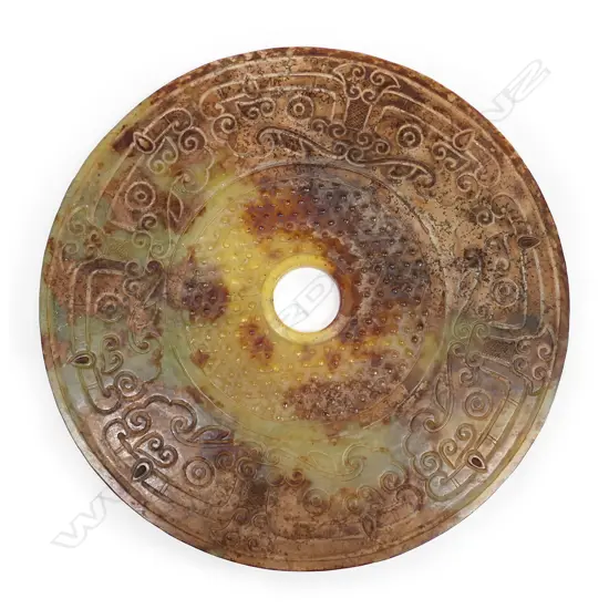 A large Chinese archaic style carved jade 'Lucky' coin