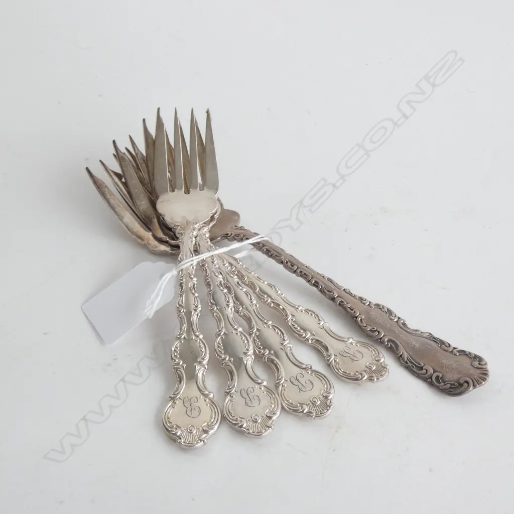 FOUR SILVER PLATE CAKE FORKS AND A LARGER SILVER CAKE FORK Image 1++