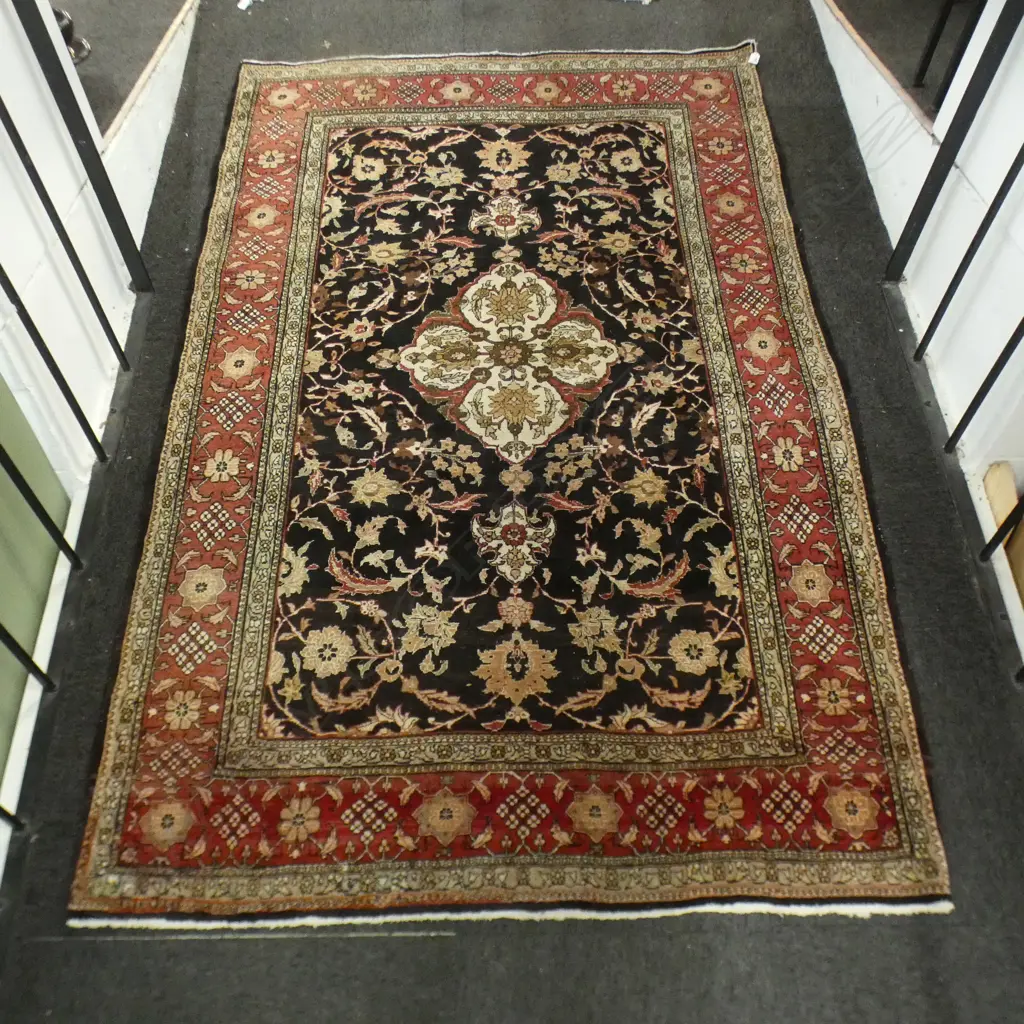 IRANIAN HAND KNOTTED RUG, BLACK GROUND CNETRAL FLORAL MEDALLION & ISLIMI TENDRILS. 2180 x 1440mm Image 1++