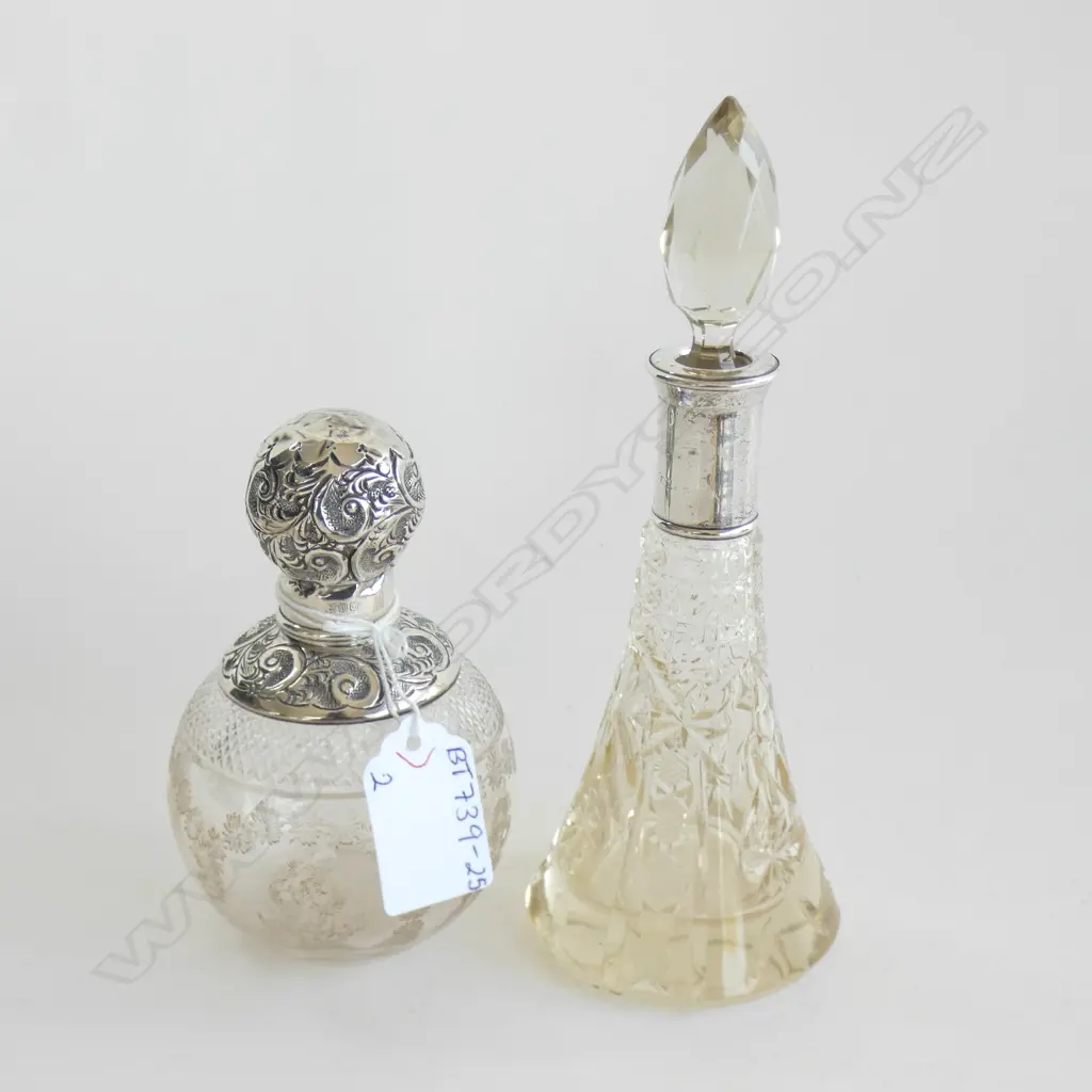 2 VINTAGE GLASS SCENT BOTTLES; 1 WITH STG COLLAR & LID LONDON C1916 (H110MM) & 1 STG COLLAR C 1900 (H170MM) Image 1++