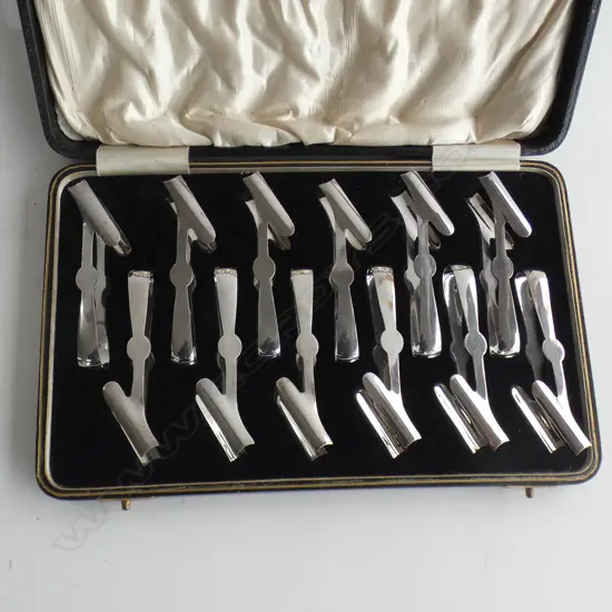 BOXED SET OF 12 SILVER PLATE INDIVIDUAL ASPARAGUS SERVERS