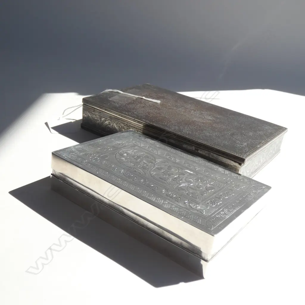 2 CIGARETTE BOXES, ONE SILVER PLATE, THE OTHER PROBABLY EGYPTIAN SILVER. W.170mm Image 1++