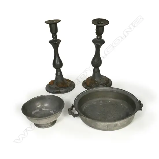 Four antique pewter pieces including a pair of baluster column candlesticks and two bowls of which one is handled. H.290mm