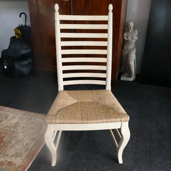 6 WHITE PAINTED LADDER BACK CHAIRS; CANE SEATS one chair chewed by dog