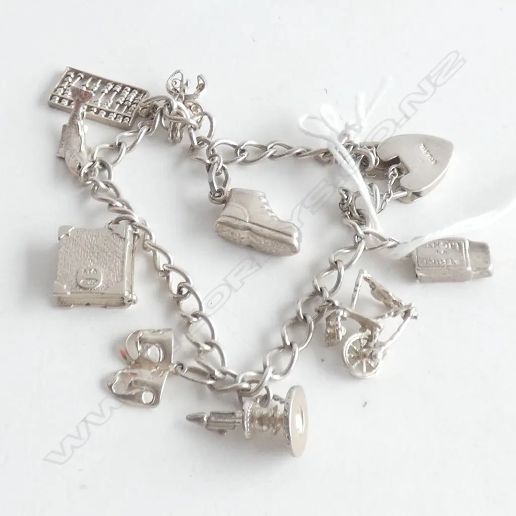 SILVER CHARM BRACELET WITH 9 CHARMS  22.67gm Image 1++