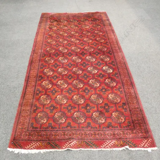 HAND KNOTTED DARK RED WOOL PILE RUG...